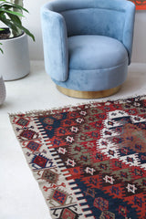 Vintage kilim rug in living room setting, bright colors, wild shaman, soft rug, bold color, Portland, Oregon, rug store, rug shop, local shop, vintage rug, modern kilim, warm colors, antique rug, antique kilim