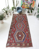 Vintage kilim rug in living room setting, bright colors, wild shaman, soft rug, bold color, Portland, Oregon, rug store, rug shop, local shop, vintage rug, modern kilim, warm colors, antique rug, antique kilim