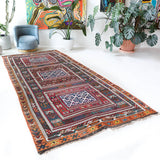 Vintage kilim rug in living room setting, bright colors, wild shaman, soft rug, bold color, Portland, Oregon, rug store, rug shop, local shop, vintage rug, modern kilim, warm colors, antique rug, antique kilim