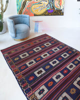 Vintage kilim rug in living room setting, old rug, antique rug, pastel colors, faded colors, Turkish rug, vintage rug, soft rug, Portland, Oregon, rug store, rug shop, local shop, earthy tones, earthy colors, warm colors