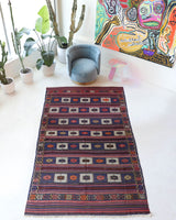 Vintage kilim rug in living room setting, old rug, antique rug, pastel colors, faded colors, Turkish rug, vintage rug, soft rug, Portland, Oregon, rug store, rug shop, local shop, earthy tones, earthy colors, warm colors