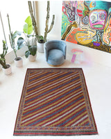 Vintage kilim rug in living room setting, old rug, antique rug, pastel colors, faded colors, Turkish rug, vintage rug, soft rug, Portland, Oregon, rug store, rug shop, local shop, earthy tones, earthy colors, warm colors