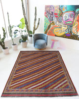 Vintage kilim rug in living room setting, old rug, antique rug, pastel colors, faded colors, Turkish rug, vintage rug, soft rug, Portland, Oregon, rug store, rug shop, local shop, earthy tones, earthy colors, warm colors