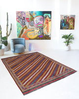 Vintage kilim rug in living room setting, old rug, antique rug, pastel colors, faded colors, Turkish rug, vintage rug, soft rug, Portland, Oregon, rug store, rug shop, local shop, earthy tones, earthy colors, warm colors