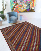 Vintage kilim rug in living room setting, old rug, antique rug, pastel colors, faded colors, Turkish rug, vintage rug, soft rug, Portland, Oregon, rug store, rug shop, local shop, earthy tones, earthy colors, warm colors