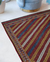 Vintage kilim rug in living room setting, old rug, antique rug, pastel colors, faded colors, Turkish rug, vintage rug, soft rug, Portland, Oregon, rug store, rug shop, local shop, earthy tones, earthy colors, warm colors