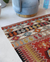 Vintage kilim rug in living room setting, bright colors, wild shaman, soft rug, bold color, Portland, Oregon, rug store, rug shop, local shop, vintage rug, modern kilim, warm colors, antique kilim rug