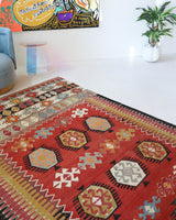 Vintage kilim rug in living room setting, bright colors, wild shaman, soft rug, bold color, Portland, Oregon, rug store, rug shop, local shop, vintage rug, modern kilim, warm colors, antique kilim rug