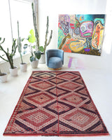 Vintage kilim rug in living room setting, old rug, antique rug, pastel colors, faded colors, Turkish rug, vintage rug, soft rug, Portland, Oregon, rug store, rug shop, local shop, earthy tones, earthy colors, warm colors