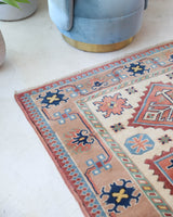 Vintage Turkish rug in living room setting, old rug, antique rug, pastel colors, faded colors, Turkish rug, vintage rug, soft rug, Portland, Oregon, rug store, rug shop, local shop