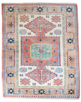 Vintage Turkish rug in living room setting, old rug, antique rug, pastel colors, faded colors, Turkish rug, vintage rug, soft rug, Portland, Oregon, rug store, rug shop, local shop