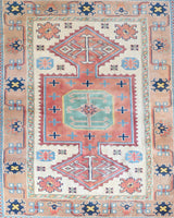 Vintage Turkish rug in living room setting, old rug, antique rug, pastel colors, faded colors, Turkish rug, vintage rug, soft rug, Portland, Oregon, rug store, rug shop, local shop