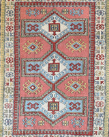 Vintage Turkish rug in living room setting, old rug, antique rug, pastel colors, faded colors, Turkish rug, vintage rug, soft rug, Portland, Oregon, rug store, rug shop, local shop