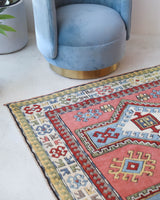 Vintage Turkish rug in living room setting, old rug, antique rug, pastel colors, faded colors, Turkish rug, vintage rug, soft rug, Portland, Oregon, rug store, rug shop, local shop
