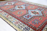 Vintage Turkish rug in living room setting, old rug, antique rug, pastel colors, faded colors, Turkish rug, vintage rug, soft rug, Portland, Oregon, rug store, rug shop, local shop