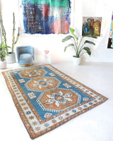 Vintage Turkish rug in living room setting, old rug, antique rug, pastel colors, faded colors, Turkish rug, vintage rug, soft rug, Portland, Oregon, rug store, rug shop, local shop