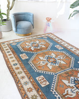 Vintage Turkish rug in living room setting, old rug, antique rug, pastel colors, faded colors, Turkish rug, vintage rug, soft rug, Portland, Oregon, rug store, rug shop, local shop