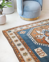 Vintage Turkish rug in living room setting, old rug, antique rug, pastel colors, faded colors, Turkish rug, vintage rug, soft rug, Portland, Oregon, rug store, rug shop, local shop