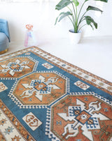 Vintage Turkish rug in living room setting, old rug, antique rug, pastel colors, faded colors, Turkish rug, vintage rug, soft rug, Portland, Oregon, rug store, rug shop, local shop