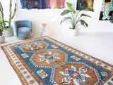 Vintage Turkish rug in living room setting, old rug, antique rug, pastel colors, faded colors, Turkish rug, vintage rug, soft rug, Portland, Oregon, rug store, rug shop, local shop