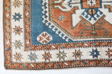 Vintage Turkish rug in living room setting, old rug, antique rug, pastel colors, faded colors, Turkish rug, vintage rug, soft rug, Portland, Oregon, rug store, rug shop, local shop