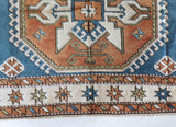Vintage Turkish rug in living room setting, old rug, antique rug, pastel colors, faded colors, Turkish rug, vintage rug, soft rug, Portland, Oregon, rug store, rug shop, local shop