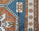 Vintage Turkish rug in living room setting, old rug, antique rug, pastel colors, faded colors, Turkish rug, vintage rug, soft rug, Portland, Oregon, rug store, rug shop, local shop