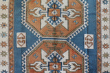 Vintage Turkish rug in living room setting, old rug, antique rug, pastel colors, faded colors, Turkish rug, vintage rug, soft rug, Portland, Oregon, rug store, rug shop, local shop