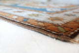 Vintage Turkish rug in living room setting, old rug, antique rug, pastel colors, faded colors, Turkish rug, vintage rug, soft rug, Portland, Oregon, rug store, rug shop, local shop