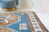 Vintage Turkish rug in living room setting, old rug, antique rug, pastel colors, faded colors, Turkish rug, vintage rug, soft rug, Portland, Oregon, rug store, rug shop, local shop