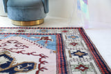Vintage Turkish rug in a living room setting, pile rug, Turkish rug, vintage rug, portland, rug shop, bright colors, wild shaman, soft rug, bold color, Portland, Oregon, rug store, rug shop, local shop, antique rug