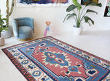 Vintage Turkish rug in a living room setting, pile rug, Turkish rug, vintage rug, portland, rug shop, bright colors, wild shaman, soft rug, bold color, Portland, Oregon, rug store, rug shop, local shop, antique rug