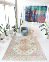 Vintage Turkish rug in living room setting, old rug, antique rug, pastel colors, faded colors, Turkish rug, vintage rug, soft rug, Portland, Oregon, rug store, rug shop, local shop