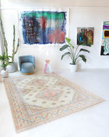 Vintage Turkish rug in living room setting, old rug, antique rug, pastel colors, faded colors, Turkish rug, vintage rug, soft rug, Portland, Oregon, rug store, rug shop, local shop