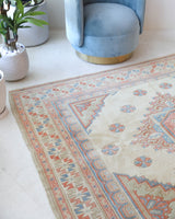 Vintage Turkish rug in living room setting, old rug, antique rug, pastel colors, faded colors, Turkish rug, vintage rug, soft rug, Portland, Oregon, rug store, rug shop, local shop