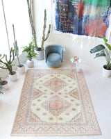 Vintage Turkish rug in living room setting, old rug, antique rug, pastel colors, faded colors, Turkish rug, vintage rug, soft rug, Portland, Oregon, rug store, rug shop, local shop