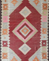 Vintage kilim rug in living room setting, old rug, antique rug, pastel colors, faded colors, Turkish rug, vintage rug, soft rug, Portland, Oregon, rug store, rug shop, local shop, earthy tones, earthy colors, warm colors