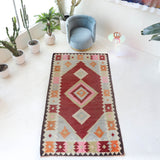 Vintage kilim rug in living room setting, old rug, antique rug, pastel colors, faded colors, Turkish rug, vintage rug, soft rug, Portland, Oregon, rug store, rug shop, local shop, earthy tones, earthy colors, warm colors