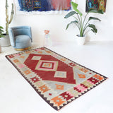 Vintage kilim rug in living room setting, old rug, antique rug, pastel colors, faded colors, Turkish rug, vintage rug, soft rug, Portland, Oregon, rug store, rug shop, local shop, earthy tones, earthy colors, warm colors