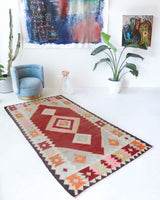 Vintage kilim rug in living room setting, old rug, antique rug, pastel colors, faded colors, Turkish rug, vintage rug, soft rug, Portland, Oregon, rug store, rug shop, local shop, earthy tones, earthy colors, warm colors