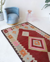 Vintage kilim rug in living room setting, old rug, antique rug, pastel colors, faded colors, Turkish rug, vintage rug, soft rug, Portland, Oregon, rug store, rug shop, local shop, earthy tones, earthy colors, warm colors