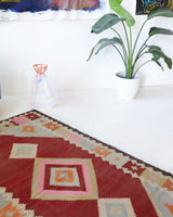 Vintage kilim rug in living room setting, old rug, antique rug, pastel colors, faded colors, Turkish rug, vintage rug, soft rug, Portland, Oregon, rug store, rug shop, local shop, earthy tones, earthy colors, warm colors