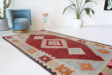 Vintage kilim rug in living room setting, old rug, antique rug, pastel colors, faded colors, Turkish rug, vintage rug, soft rug, Portland, Oregon, rug store, rug shop, local shop, earthy tones, earthy colors, warm colors