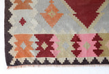 Vintage kilim rug in living room setting, old rug, antique rug, pastel colors, faded colors, Turkish rug, vintage rug, soft rug, Portland, Oregon, rug store, rug shop, local shop, earthy tones, earthy colors, warm colors