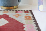 Vintage kilim rug in living room setting, old rug, antique rug, pastel colors, faded colors, Turkish rug, vintage rug, soft rug, Portland, Oregon, rug store, rug shop, local shop, earthy tones, earthy colors, warm colors