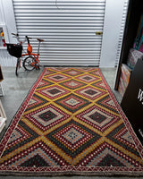 Vintage kilim rug in living room setting, bright colors, wild shaman, soft rug, bold color, Portland, Oregon, rug store, rug shop, local shop, vintage rug, modern kilim, warm colors, antique rug, antique kilim