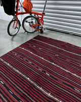 Vintage kilim rug in living room setting, bright colors, wild shaman, soft rug, bold color, Portland, Oregon, rug store, rug shop, local shop, vintage rug, modern kilim, warm colors, antique rug, antique kilim