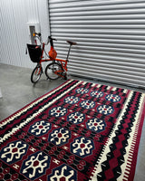 Vintage kilim rug in living room setting, bright colors, wild shaman, soft rug, bold color, Portland, Oregon, rug store, rug shop, local shop, vintage rug, modern kilim, warm colors, antique rug, antique kilim