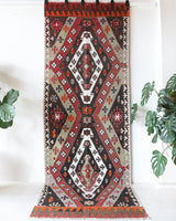 Vintage Turkish runner rug in a living room setting, pile rug, Turkish rug, vintage rug, portland, rug shop, bright colors, wild shaman, soft rug, bold color, Portland, Oregon, rug store, rug shop, local shop, antique rug