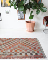 Vintage Turkish runner rug in living room setting, old rug, antique rug, pastel colors, faded colors, Turkish rug, vintage rug, soft rug, Portland, Oregon, rug store, rug shop, local shop